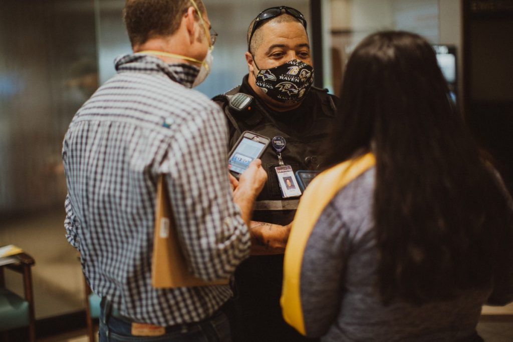 Officer Paul Blackman speaks to the Healthcare is Human podcast producers in the lobby of the Berkeley Medical Center during a time when no visitors were allowed in the hospital. Photo: Molly Humphreys/Healthcare is Human