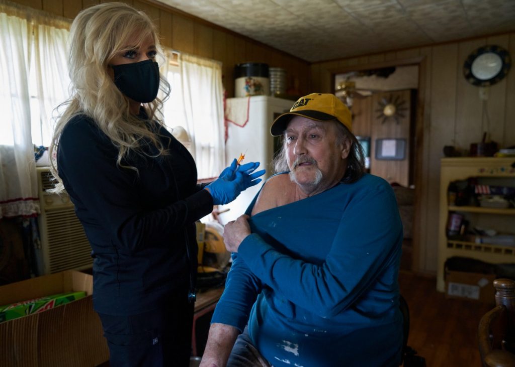 Dr. Teresa Tyson and the Health Wagon team have started to administer COVID-19 vaccines in this part of Appalachia by traveling door-to-door. Here, Tyson prepares to administer a vaccine to Marty Wells at his home in Norton, Virginia. Photo: Stacy Kranitz/100 Days in Appalachia