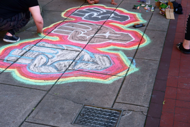 Over days and weeks, the protests on the Chambersburg Square grew and evolved. A few days in, some people began to use art to express their emotions and goals for the community. Chalk art was created with an "all hands on deck" approach; everyone from practicing artists to curious toddlers participated. Photo: Madison Mellinger