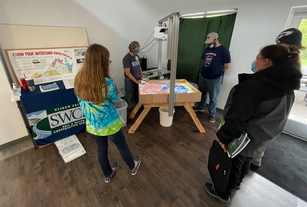 Educators use an augmented reality display to discuss how to integrate locally-relevant pollution and environmental issues into their curricula at an annual symposium in St. Paul, Virginia. Photo: Provided